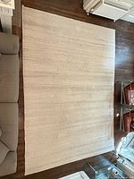 Top view showing full rug and surrounding furniture for scale