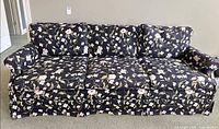 Full front view of navy floral 3-cushion sofa