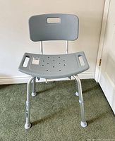Front view of grey adjustable shower chair