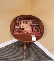 Full view of round tilt-top table showing needlepoint inlay and tripod base
