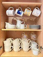 Cabinet with all mugs, pitchers and plates