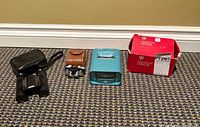 All items laid out: binocular case, binoculars, opera glass case, opera glasses, slide viewer, viewer box
