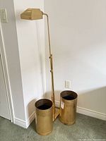 Full view of floor lamp and two umbrella stands