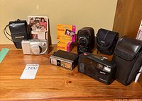 Group shot showing both cameras, flash, exposure meter, film boxes and carry cases