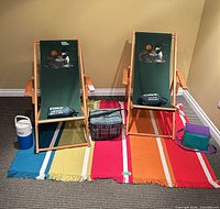Two folding chairs, rug, jug, cooler bags and pillows overview