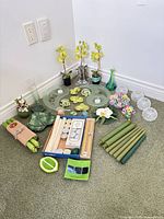 group view of candles, floral arrangements, dishes, vases and spheres