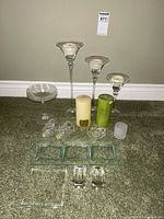 All candle holders, candles and trays arranged