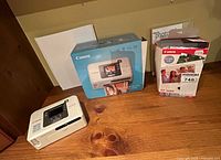 Lot overview showing printer, box, and ink/paper kit