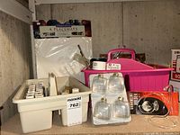 Overview of lot: trays with paint bottles, placemats, pink tote with craft items, ornament pack