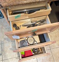 Three drawers showing knife holder, flatware tray, utensil drawer