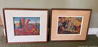 Both framed landscape paintings side by side