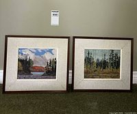 Both framed landscape paintings side by side