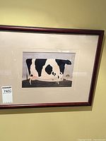 Full view of framed cow print on wall