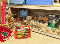 Overall view of wrapping paper rolls, ribbons, tissue paper, holiday décor on shelves