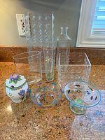 Group view of all glass vases, bowls, and porcelain jar