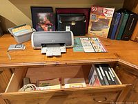 Overall lot on desk showing printer, radio, portfolio, file box, folders, binders and stationery
