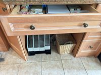 Drawer showing tapes, paper pad, note cube, ruler, hole punch, pens in organizers