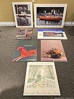 Seven posters arranged on floor