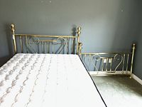 Brass bed frame assembled with mattress