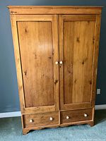 Front view showing double doors, two drawers and knobs
