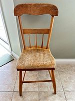 Front view of wooden chair showing seat and backrest