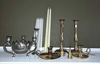 Group shot of all candle holders, tapers, snuffer