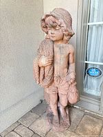 Full front view of terracotta boy statue showing height and details
