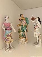 All three porcelain figurines on shelf
