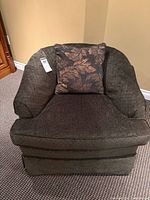 front view of upholstered armchair showing pillow and seat