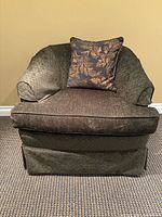 front view of upholstered arm chair with pillow