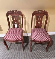Front view of both matching carved dining chairs