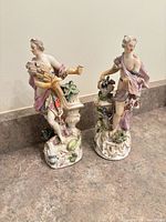 Both porcelain figurines side by side on counter
