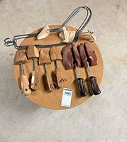 Top view showing wooden shoe trees, wire sock blockers on round table