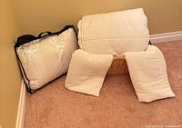 Basket with quilt, two shams and pillow in bag