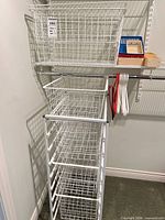 Overall view of wire storage stand, drawers, and top basket
