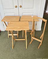 three tray tables opened next to storage stand