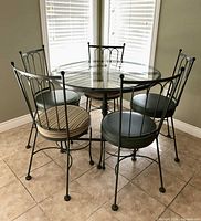 Full dining set: glass table with four visible chairs