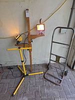 Dolly, yellow tripod stand and wood-post stand with lights