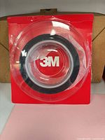 Front of opened clamshell showing 3M tape roll