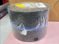 Front view shrink-wrapped black grit tape roll