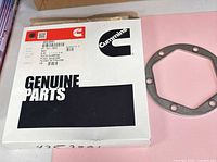 Cummins box with label showing part number 4353891 and clamping plate beside it