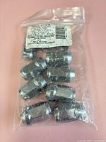 sealed bag showing all ten chrome wheel nuts