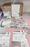 Overview of bags containing cap screws, washers and tools