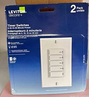 Front of sealed package showing Leviton Decora+ timer switches, 2-pack