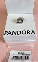Front view of Pandora charm in box