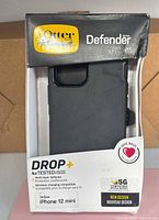 Front view of OtterBox Defender Series case in retail box
