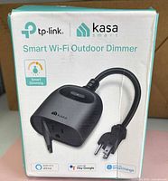 Front of box showing TP-Link Kasa Smart Wi-Fi Outdoor Dimmer image and branding