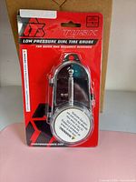 Front of sealed package showing Tusk low pressure dial tire gauge