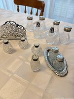 Group shot of entire lot showing shakers, napkin holder and tray