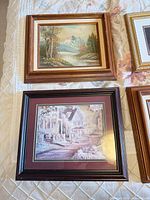 Four framed prints: two landscapes, one teapot still life, one village street scene